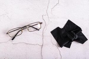 Old broken broken glasses and cloth on gray background top view photo