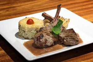 Rack of lamb with mint sauce and grilled risotto photo