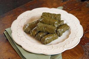 Grape leaf cigar with rice and meat photo