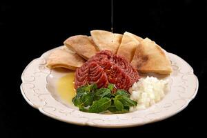 raw kibbeh with chopped onion, olive oil and Arabic bread photo