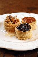 nest of Arabic sweets with grape jelly, apricot jam, chestnuts and honey photo