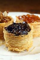 nest of Arabic sweets with grape jelly, apricot jam, chestnuts and honey photo