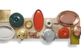 copper, crockery and silver plates, bowls and trays mounted on table seen from above photo