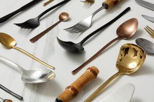 knives, cutlery, spoons and forks on a marble background photo