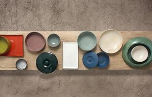 copper, crockery and silver plates, bowls and trays mounted on table seen from above photo