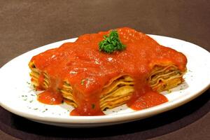 meat lasagna with tomato sauce photo