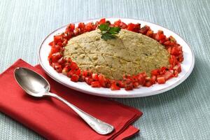 Lentil kibbeh with chopped tomatoes, a classic of Armenian cuisine photo