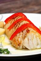 Baked cod with peppers and potatoes photo