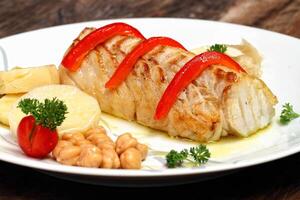 Baked cod with peppers and potatoes photo