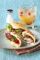 passion fruit caipirinha with cheese sandwich with lettuce and sun-dried tomatoes photo