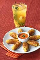 fruit caipirinha with cod fritters and red pepper photo