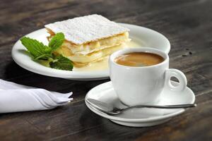 espresso coffee with sweet mille feuille on the table photo