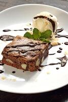 brownie with ice cream and chocolate sauce photo