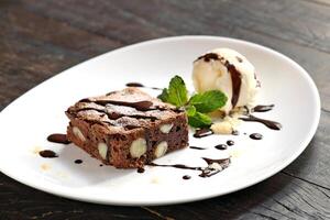 brownie with ice cream and chocolate sauce photo