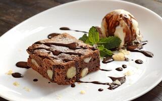 brownie with ice cream and chocolate sauce photo