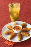 fruit caipirinha with cod fritters and red pepper photo