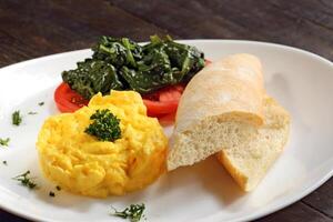 scrambled eggs with tomatoes and spinach photo