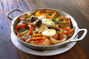 Wood-fired cod with eggs and peppers photo