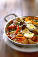 Wood-fired cod with eggs and peppers photo