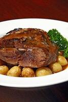 Lamb shoulder with baked potatoes and sauce photo