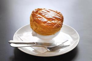 Onion soup with puff pastry crust photo