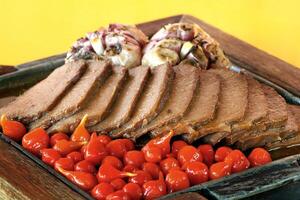 carne de sol, typical northeastern Brazilian dish with tomatoes and fried cassava photo