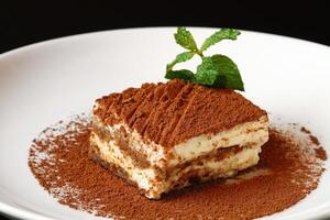 Tiramisu, classic Italian dessert covered in chocolate on top photo