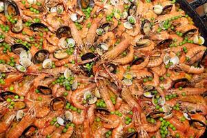Paella, classic Spanish dish with rice, vegetables and seafood photo