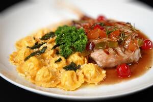 oven-baked pork rib with tomato sauce and pork ravioli photo