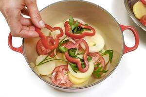 preparing fish moqueca in the red pan photo