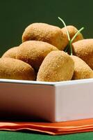 fried meat croquette in bowl on the table photo