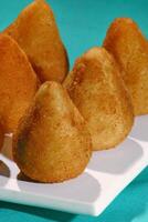 chicken coxinha, classic Brazilian snack with fried dough stuffed with shredded chicken photo