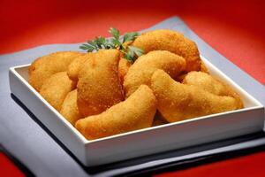 fried shrimp risoles in bowl on the table photo