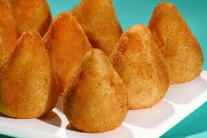 chicken coxinha, classic Brazilian snack with fried dough stuffed with shredded chicken photo