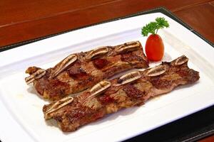 Asado de Tiras, classic cut of meat served on a plate photo