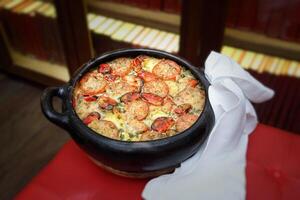 Tiella Barese, Italian classic with rice, potatoes and mussels au gratin photo