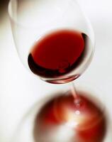 glass of red wine on white background photo