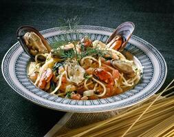 seafood spaghetti with mussels and scallops photo