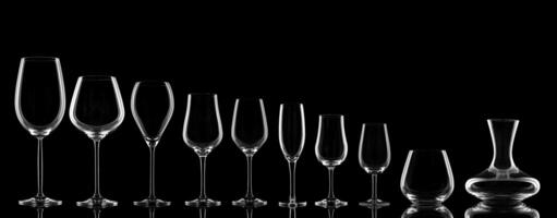 empty wine glasses specific to the type of wine on a black background photo