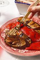 tasting of homemade handmade bread with eggplants, bacon, wine and meat in tomato sauce photo