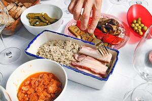 tasting of homemade handmade bread with eggplants, bacon, wine and meat in tomato sauce photo