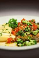 tuna steak with broccoli, sauce and boiled potatoes photo