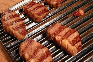 professional butcher teaching step by step how to prepare picanha, a Brazilian cut of meat photo