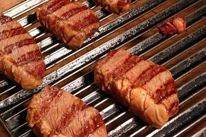 professional butcher teaching step by step how to prepare picanha, a Brazilian cut of meat photo