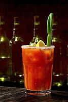 Bloody Mary, classic drink with tomato juice, vodka, lemon juice and pepper photo