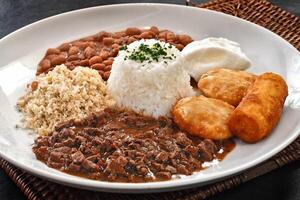 minced meat with egg, rice, beans, farofa and breaded banana photo