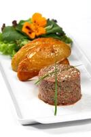 Steak Tartare, famous dish of raw meat seasoned with rustic potatoes photo