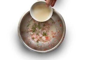 step-by-step guide to Ceviche, a classic Peruvian dish with raw fish, tiger milk sauce, lemon, pepper and red onions photo