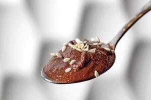 chocolate cream with sesame on spoon photo