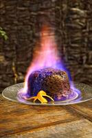 Christmas pudding being flambeed in its final step to be served photo